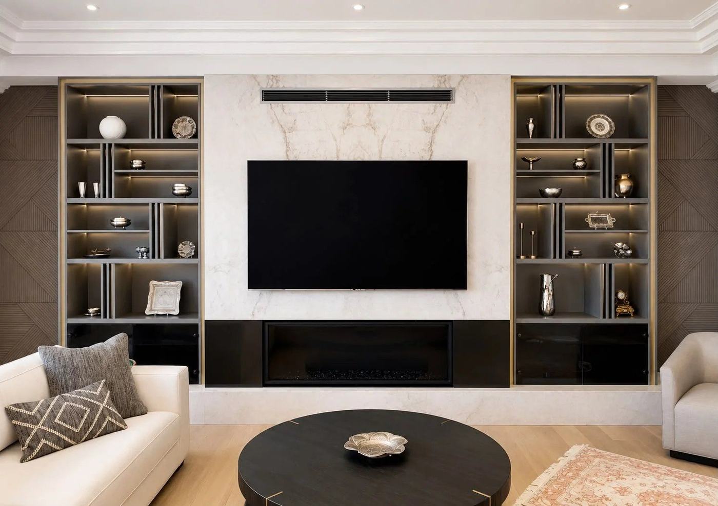 Finished basement media wall with a marble-look TV surround, linear fireplace and lit display shelving in Richmond Hill, by NewGen Renovations Vaughan