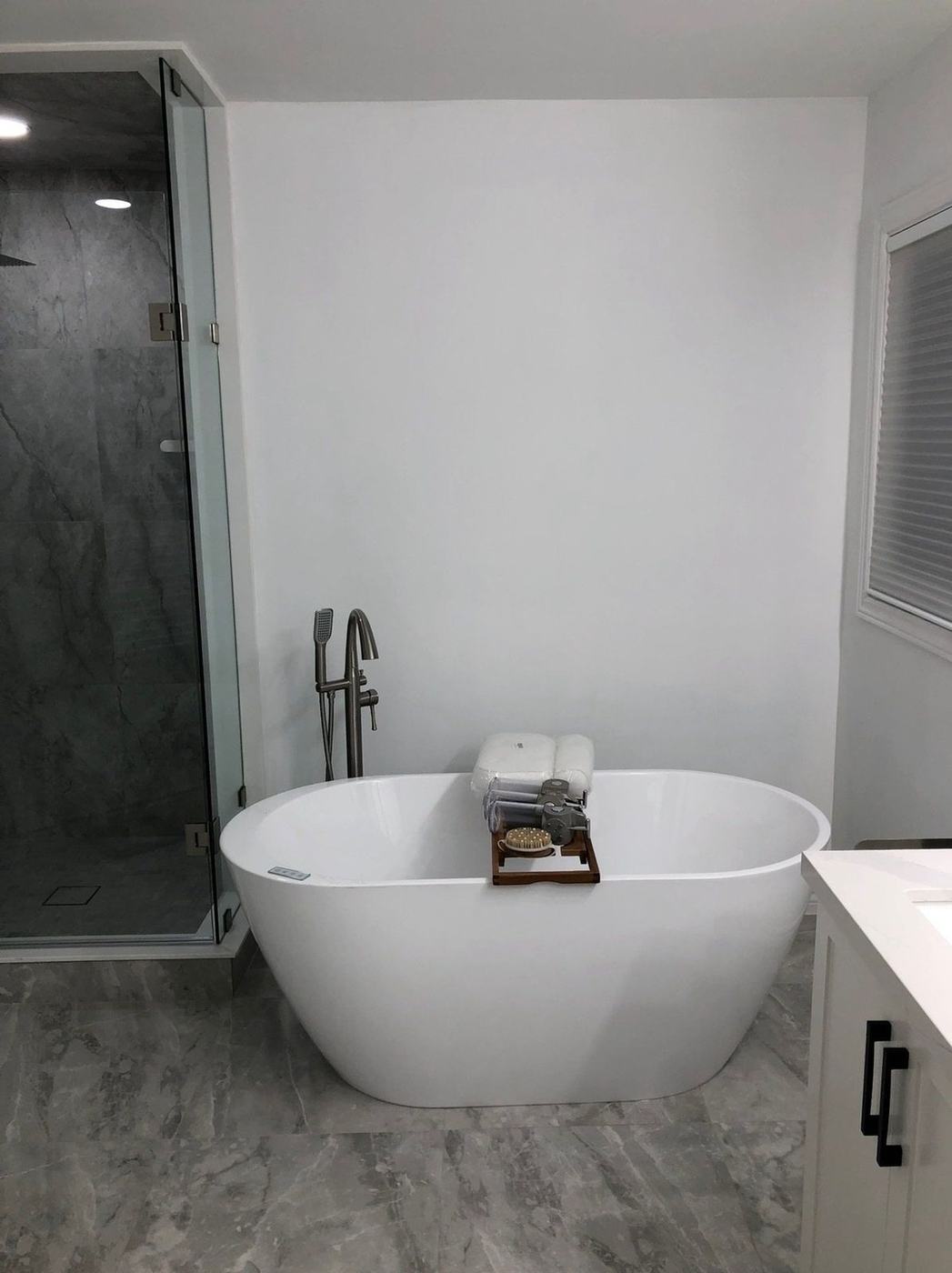 Large-format grey marble-look porcelain floor tile and steam shower wall tile, installed by NewGen Renovations Vaughan