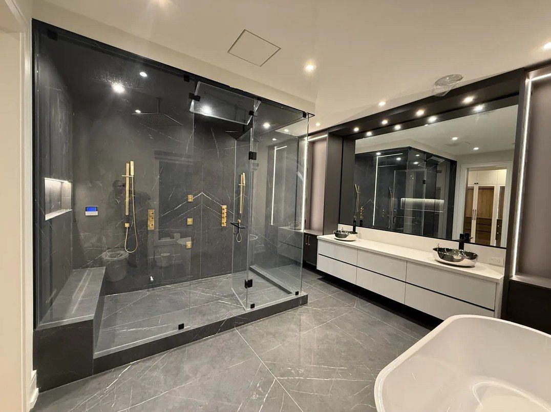 Bathroom renovation with a glass steam shower, double vanity and freestanding tub in Kleinburg, by NewGen Renovations Vaughan